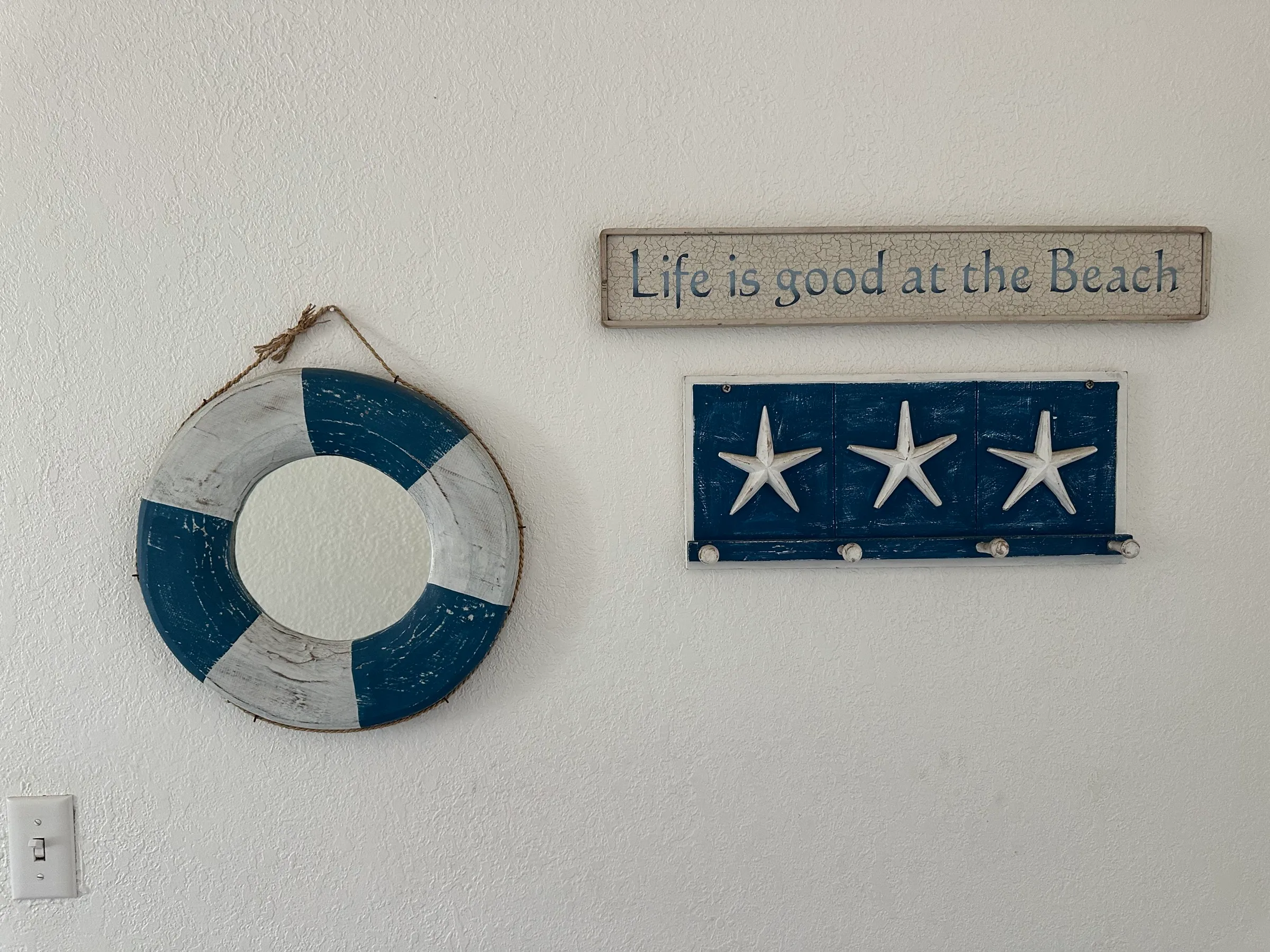 A life ring and a “Life is good at the Beach” sign on the wall