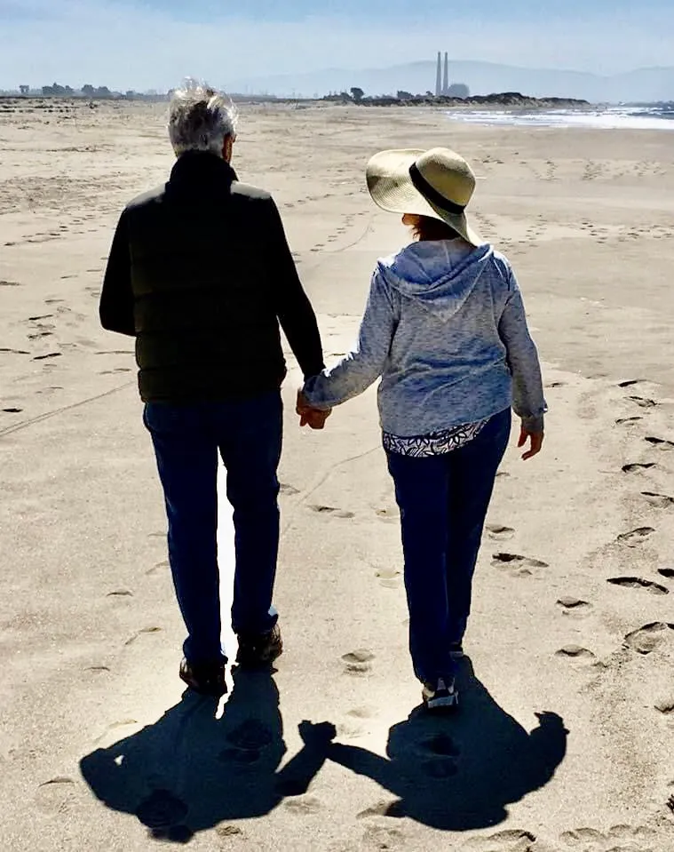 A couple walking the beach hand in hand