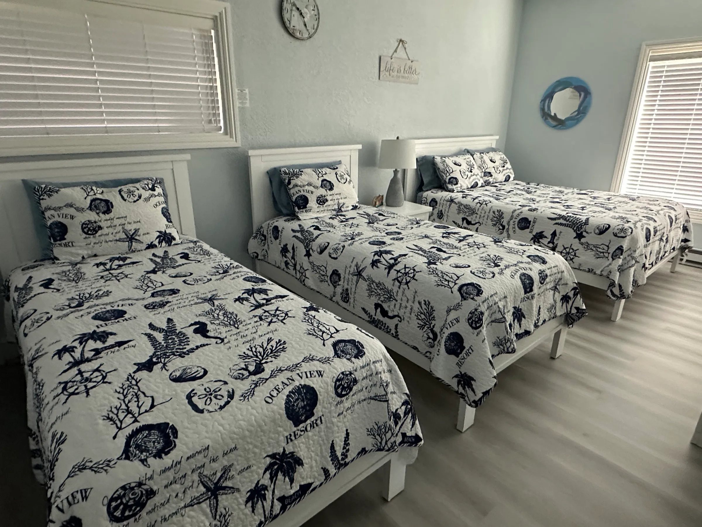 Bedroom two, with a queen bed and two twin beds
