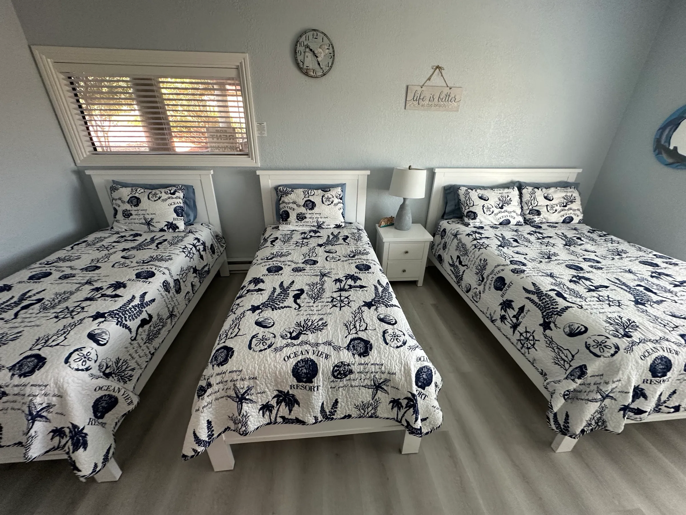 Bedroom two's three beds in a row under the window