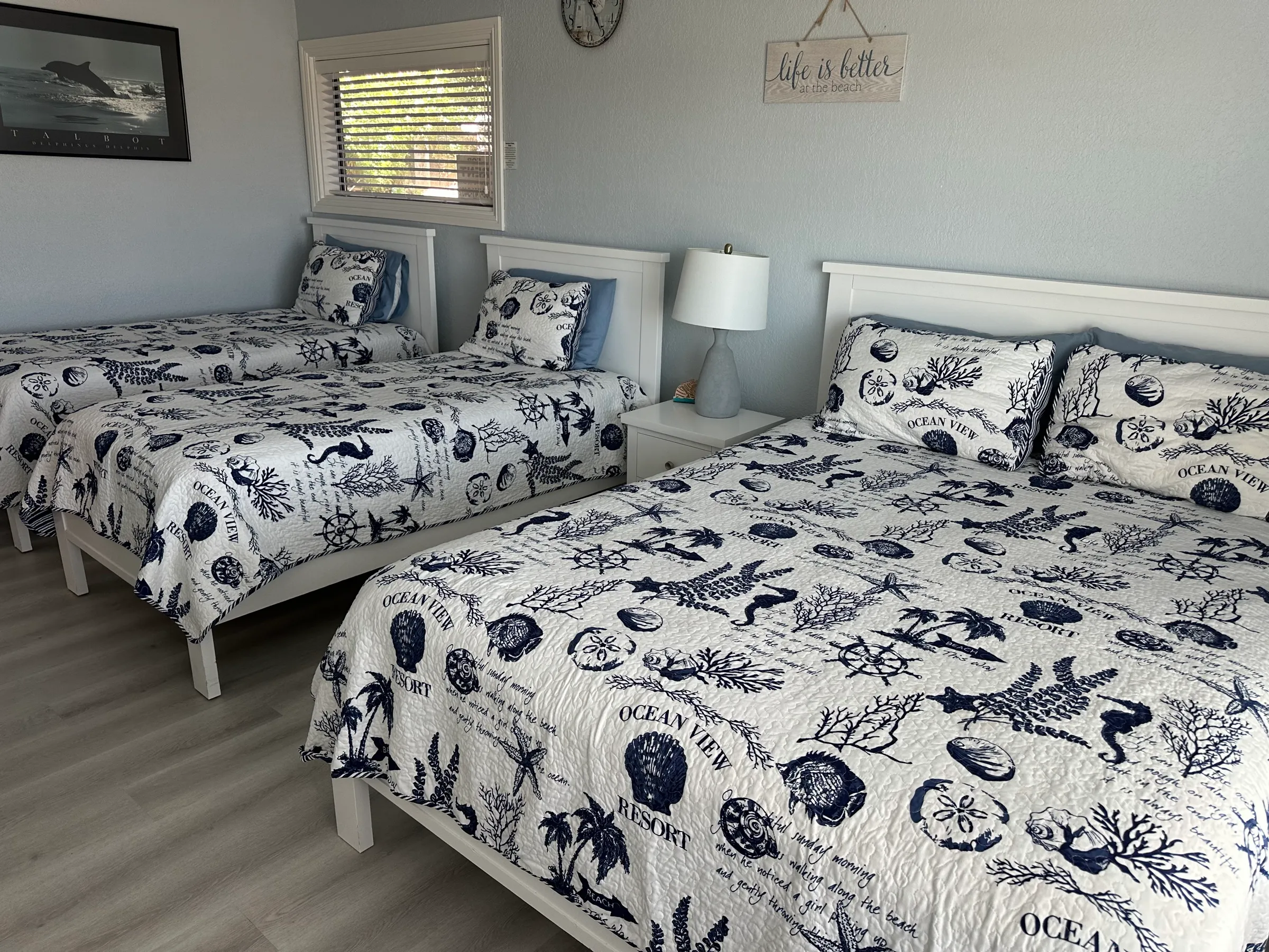 Bedroom two's queen bed, with the twin beds beyond