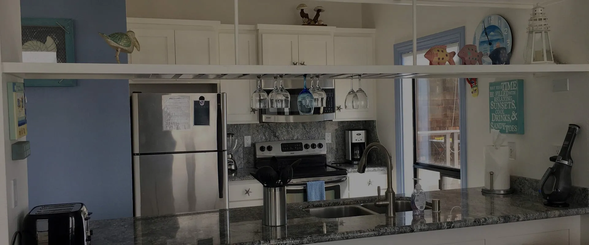 The kitchen, with its refrigerator, range and coffee maker