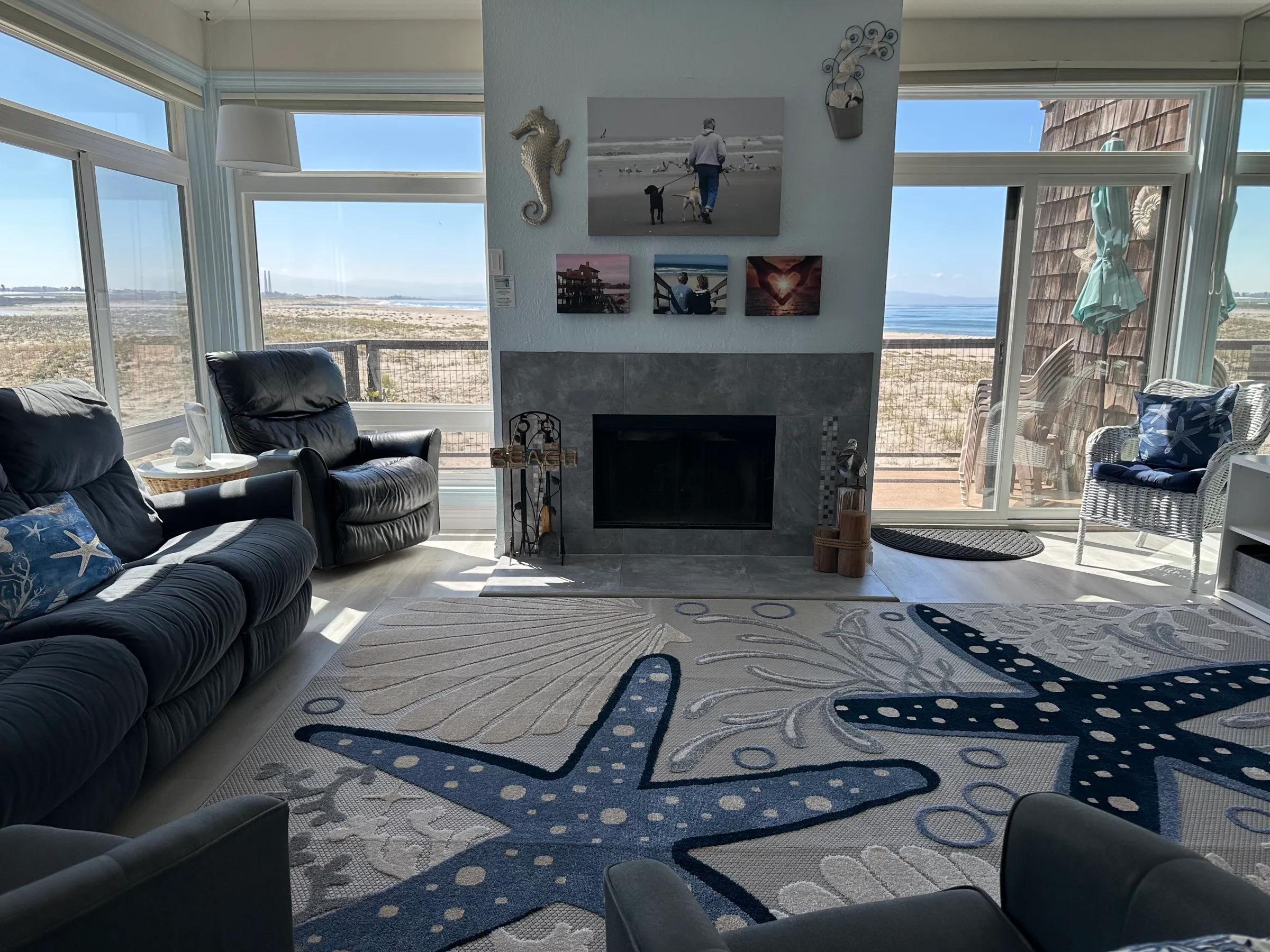 The living room, with the fireplace and ocean views on two sides