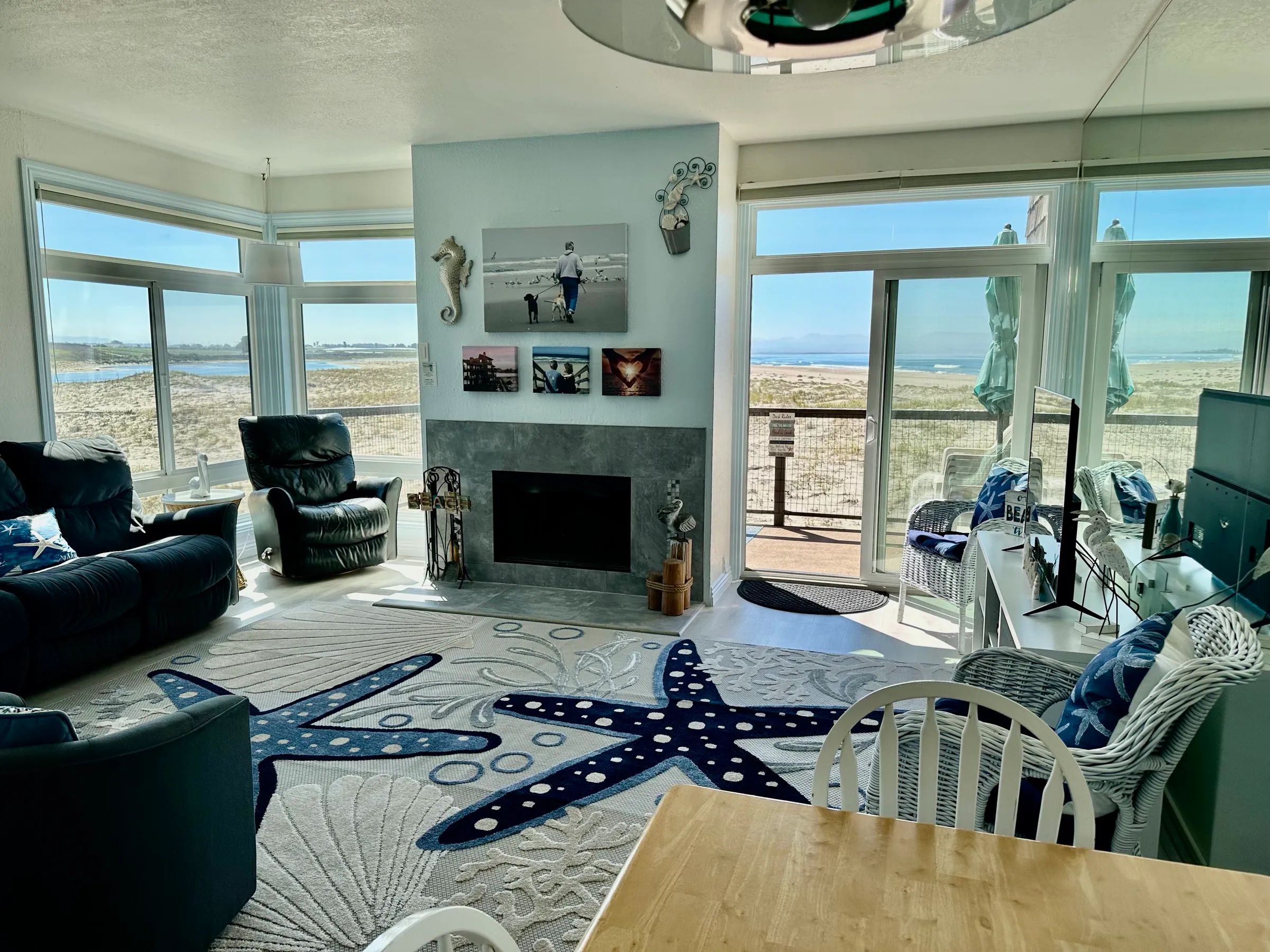 The living room from the dining table, with the balcony slider open to the beach